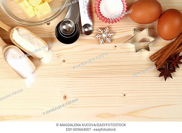 Baking utensils, flour, sugar, eggs, spices and butter with wooden copy space