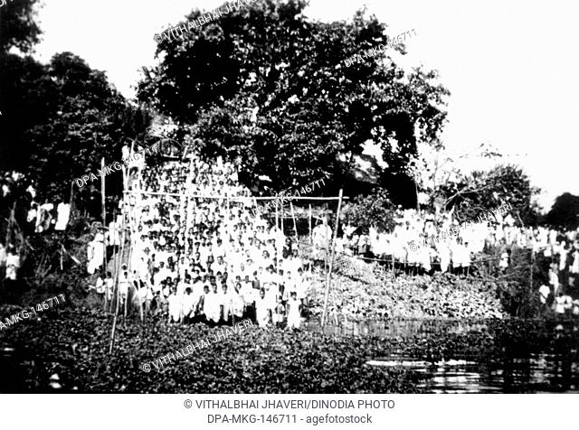 Crowds standing next to a river where Mahatma Gandhis ashes dissolve ; Dhaka ; February 1948 NO MR