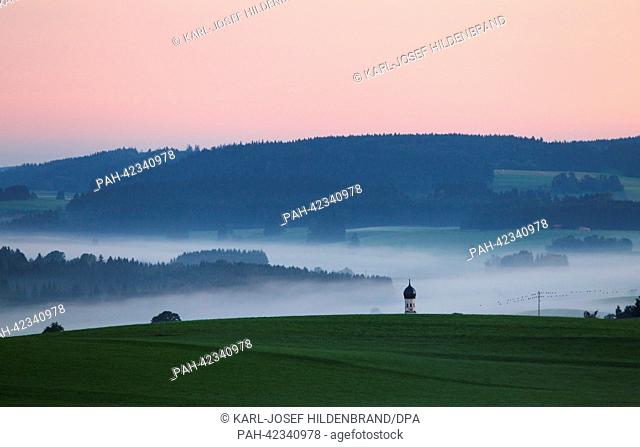 Early morning fog is visible in the valleys of the prealpine lands near Bernbeuren, Germany, 06 September 2013. Photo: KARL-JOSEF HILDENBRAND | usage worldwide