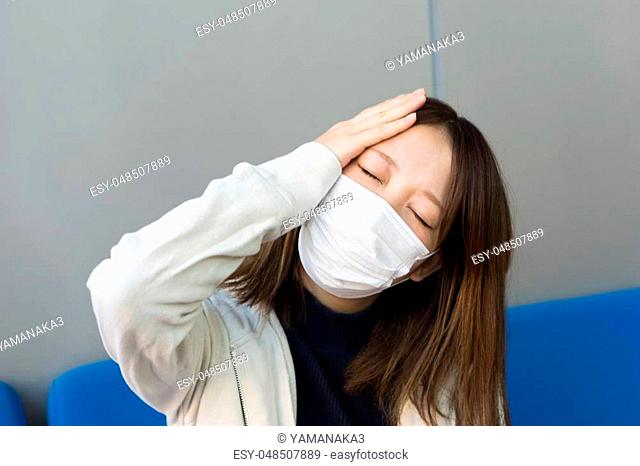 A Japanese woman with a bad headache