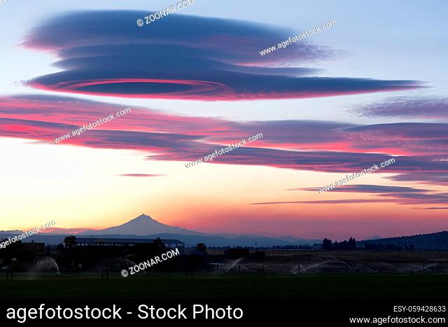 Pink hues are reflected of the clouds over Mount Jefferson Oregon