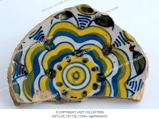 Mirror fragment of majolica dish with yellow and blue stylized flower decoration, plate dish crockery holder soil find ceramic earthenware glaze tin glaze lead...