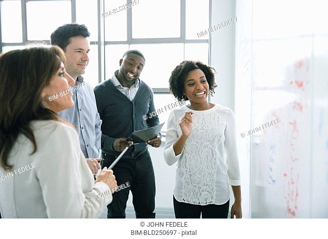 Business people reading whiteboard in meeting