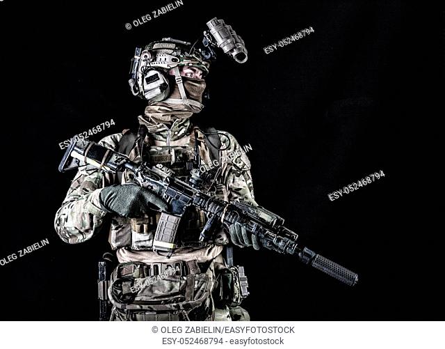 US marine riders shooter, army special forces soldier standing in darkness in mask, battle uniform, quad-tube, four lenses night vision goggles on helmet