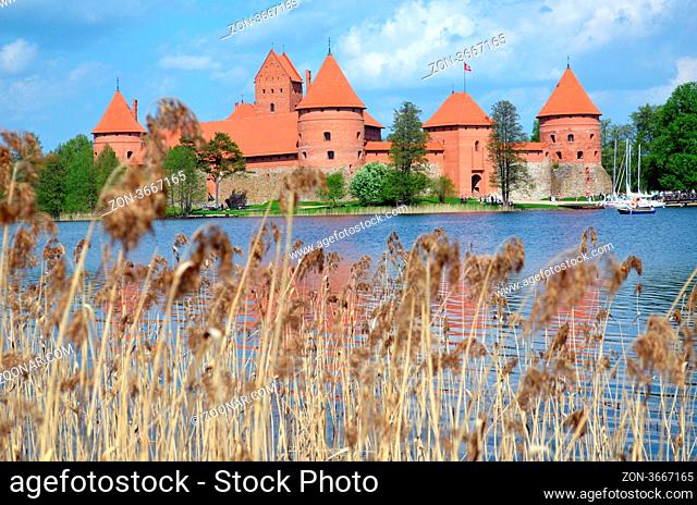 Trakai Castle surrounded by Galve lake through rushes. Most visited tourist destination in Lithuania. XIV - XV century architecture