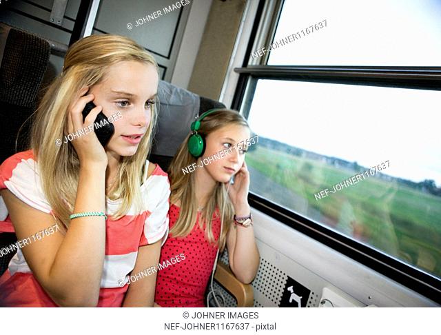 Twin sisters traveling on high speed train