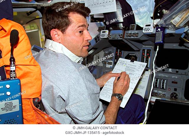 Astronaut Jeffrey S. Ashby, pilot, temporarily occupies the commander's station for a task on the flight deck of the Space Shuttle Endeavour as the seven-member...