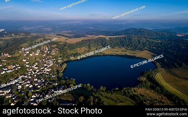 12 June 2020, Rhineland-Palatinate, Schalkenmehren: The Schalkenmehrener Maar. Aerial view with a drone. The Eifel volcanism is still active