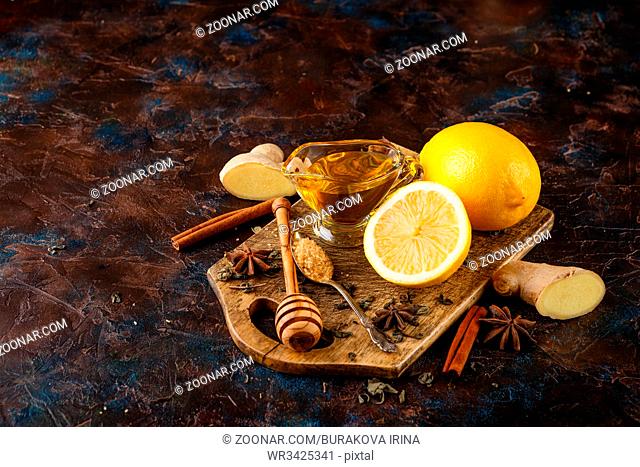 Ingredients for delicious hot tea with lemon, ginger, cinnamon, anise and honey