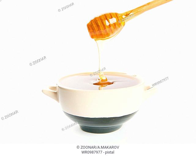 juicy honey in a cup and spoon