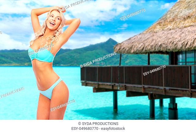 young woman posing in bikini on beach