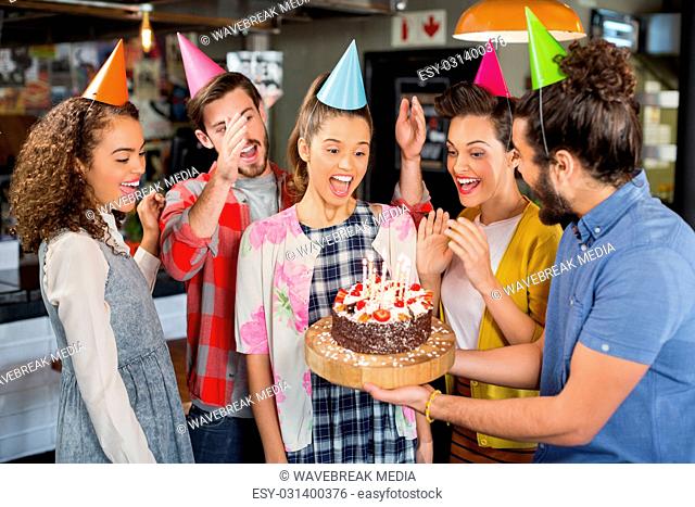 Friends celebrating birthday in restaurant