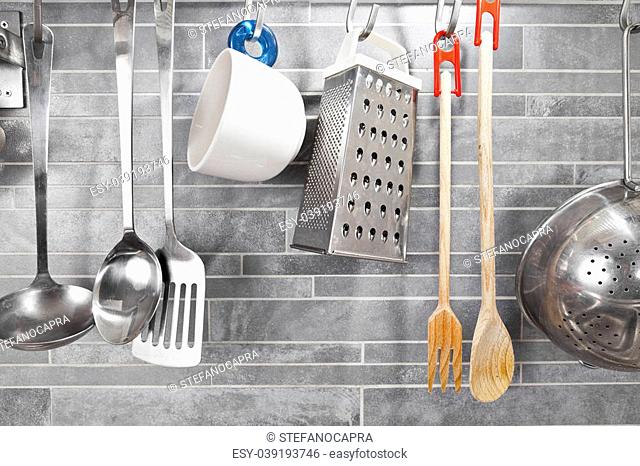 Kitchen tools on a grey tile marble wall