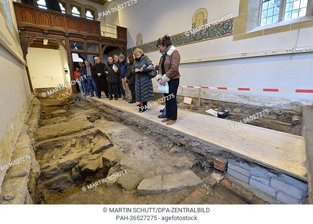 Journalists look at the remnants of a previous building from the 12th century in the Magdalena Chapel in Erfurt,  Germany, 29 January 2013