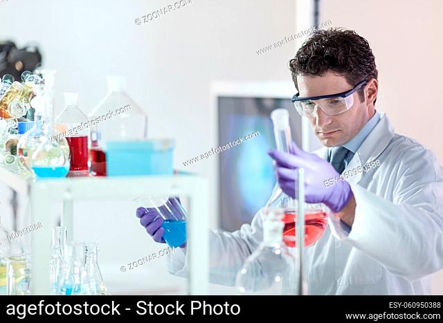 Researcher performing scientific experiment in chemical laboratory. Science, reasearch, laboratory, chemistry consept