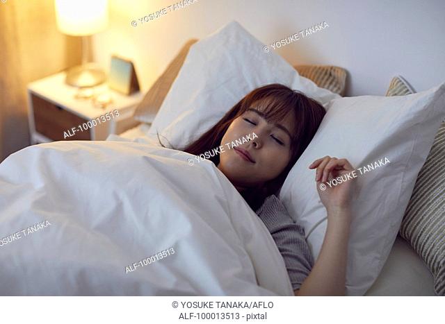 Young Japanese woman in bed