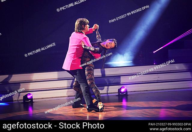 26 March 2021, North Rhine-Westphalia, Cologne: Singer Mickie Krause and professional dancer Malika Dzumaev dance on the RTL dance show ""Let's Dance""