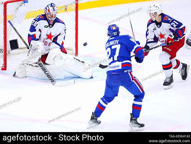 RUSSIA, ST PETERSBURG - DECEMBER 21, 2023: CSKA goaltender Ivan Fedotov, supported by Colby Williams (L-R back), defends against SKA's Emil Galimov in a 2023/24...