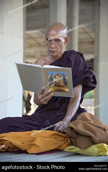 Myanmar: Bagan- Monk engaged in reciting the holy text in the vicinity of Shwezigon Pagoda