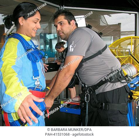 Sky Master Carlos Lucero prepares a tourist for her jump from a platform in Las Vegas, USA, 28 June 2013. As Sky Master, Lucero brings brave people down a 260m...