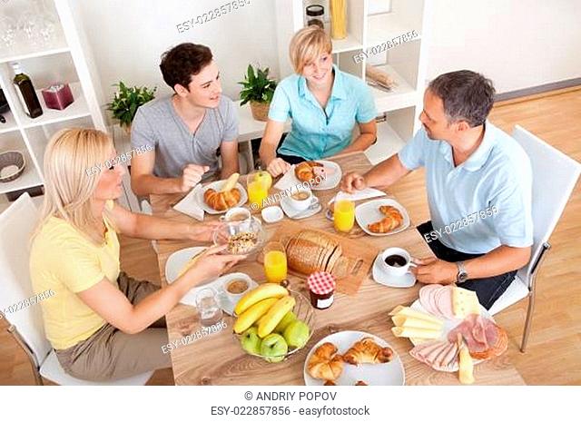 Happy family enjoying breakfast