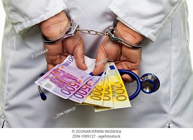 Doctor with money and handcuffs