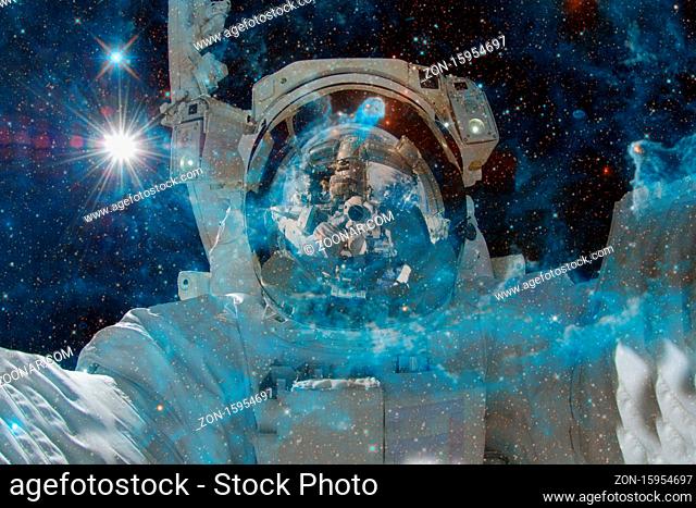 Astronaut. Nebula, cluster of stars in deep space. Science fiction art. Elements of this image furnished by NASA