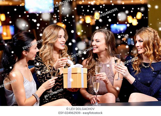 celebration, friends, new year, christmas and winter holidays concept - happy women with champagne glasses and gift box at bachelorette or birthday party at...
