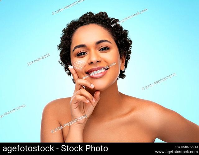 young african american woman with moisturizer