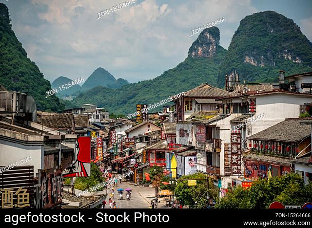 Yangshuo, China - August 2019 : Old town street lined with souvenir shops in the centre of town, Guangxi Province