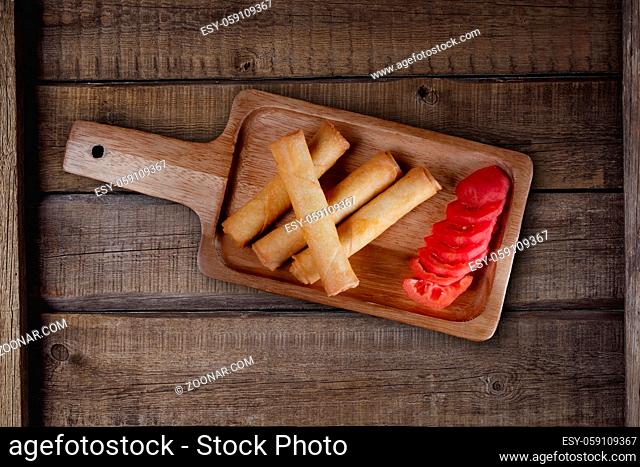 Top view of spring rolls isolated on rustic wooden background