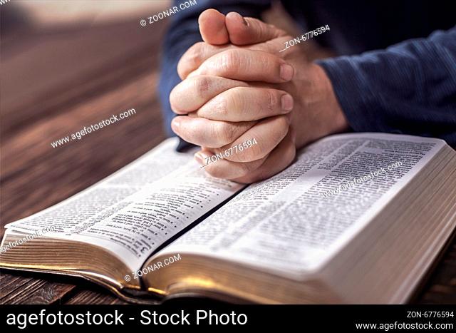 Man reading from the holy bible, close up