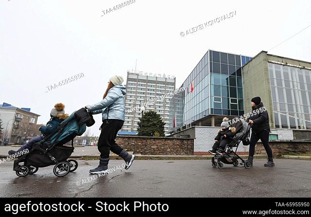 RUSSIA, ZAPOROZHYE REGION - DECEMBER 19, 2023: Women push baby strollers in a street in the city of Berdyansk. Alexei Konovalov/TASS