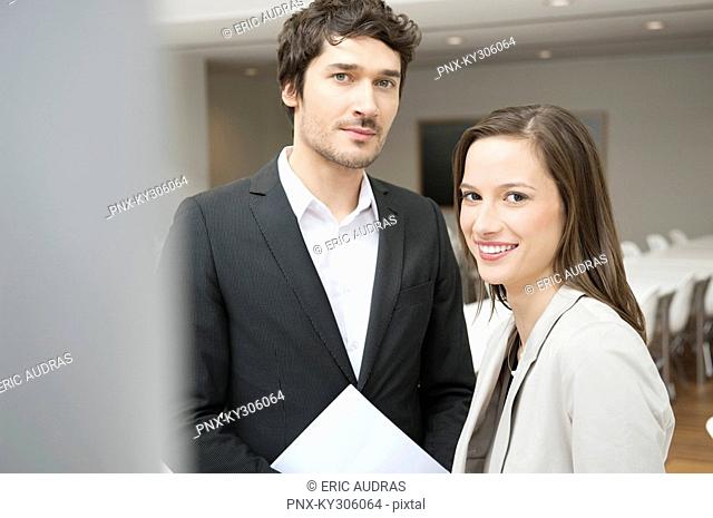 Portrait of a businesswoman smiling with her colleague beside her
