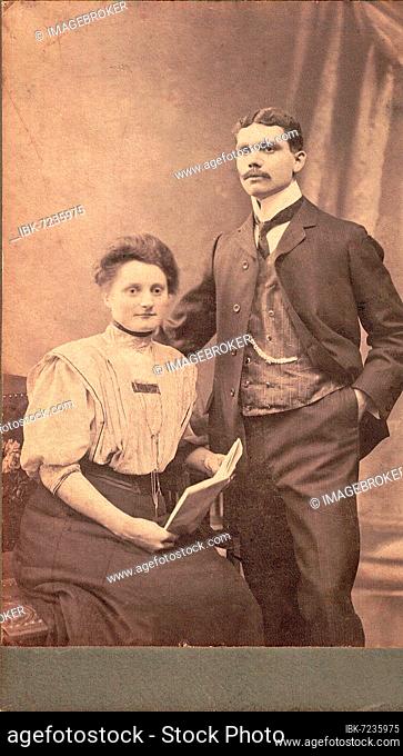 Old black and white photo, young couple in photo studio around 1910