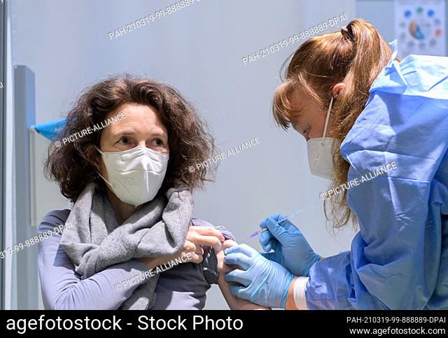 19 March 2021, Berlin: Berlin doctor Natascha Kempkes vaccinates Beatrix Mengen in Terminal C of the former Tegel Airport at the Corona Vaccination Centre with...