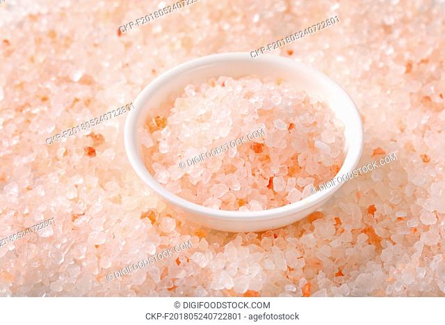 background and bowl of coarse grained Himalayan salt