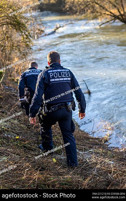 18 December 2023, Baden-Württemberg, Bingen-Hitzkofen: Police units are searching the banks of the Lauchert for a two-year-old child who has been missing since...