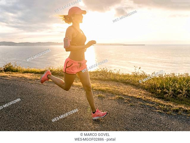 Young woman running at the sea