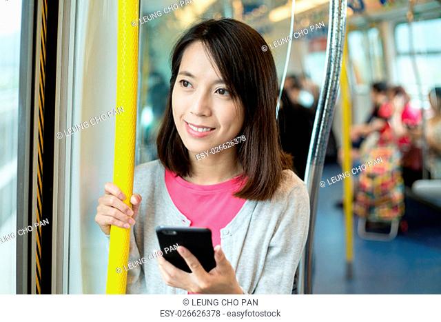 Woman use of mobile phone in train