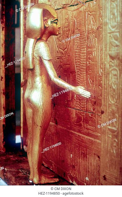 Isis the protective goddess guarding the Canopic Shrine, Tomb of Tutankhamun, Cairo, The Egyptian Museum. Tutankhamun reigned between 1336 BC and 1327 BC