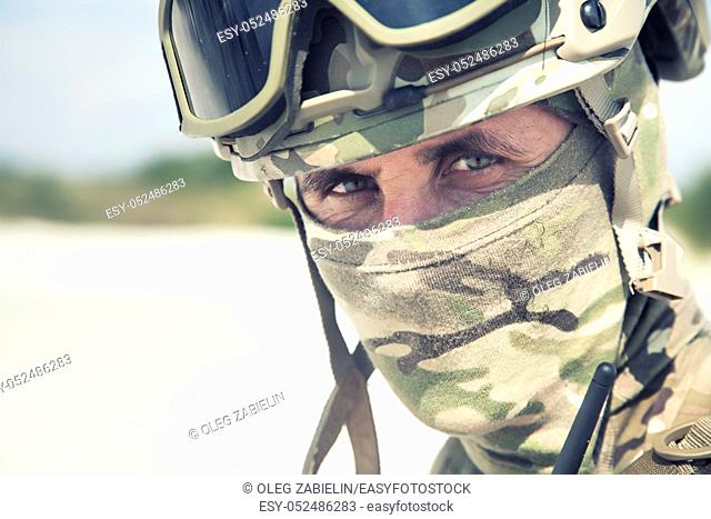 Close up, cropped portrait of airsoft, strikeball war games player, military or historical reenactment participant in tactical helmet replica