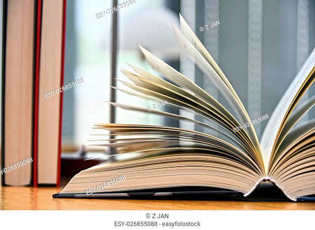 Hardcover book lying on the table in a library