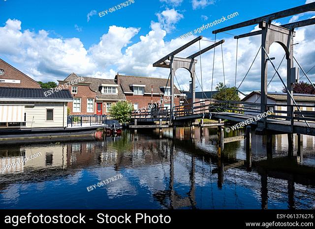 Hasselt, Overijssel, The Netherlands - Wooden old bridge over the canal with reflecting houses