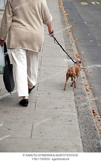 big woman with her little dog on the leash