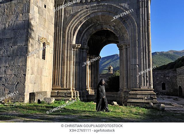 priest in front of the narthex of Sts. Paul and Peter Church, Tatev monastery, Syunik Province in southeastern Armenia, Eurasia