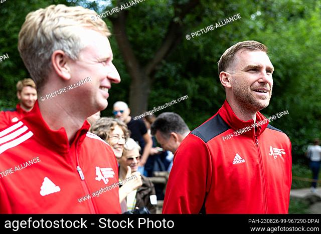 26 August 2023, Lower Saxony, Hanover: Per Mertesacker (r), former national soccer player, stands after the award of honorary sponsorship for the Rothschild...