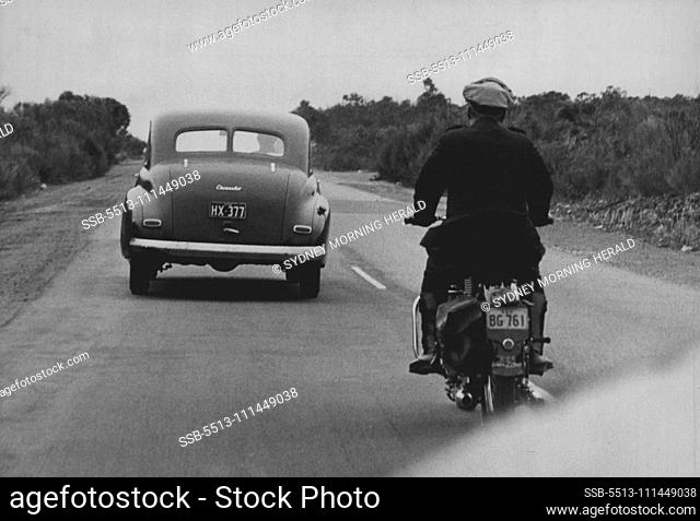 Motor-Cycle policeman following offender carefully checks speed ***** half mile. Police try to avoid use of siren which sometimes startles *****