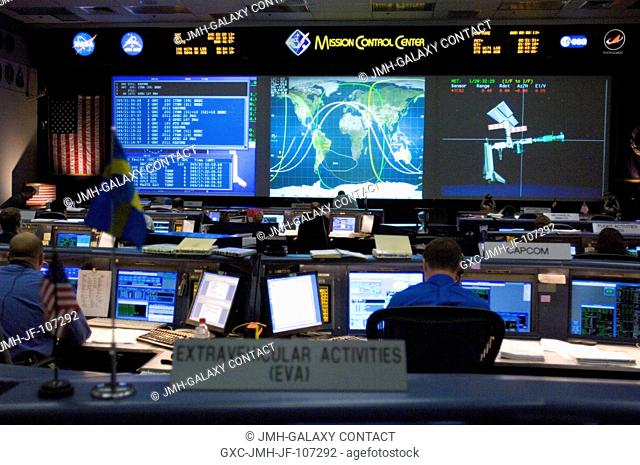 Overall view of the space shuttle flight control room in the Johnson Space Center's Mission Control Center as flight controllers support the docking of the...