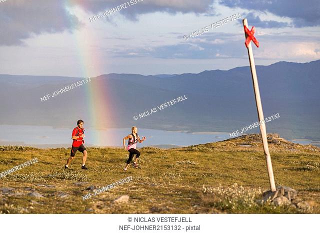 Couple jogging in mountains